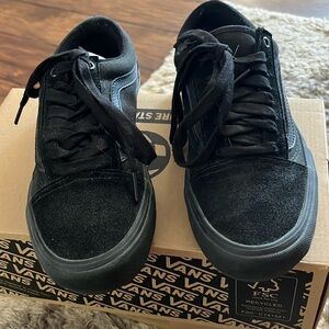 All black low top Vans Pro.